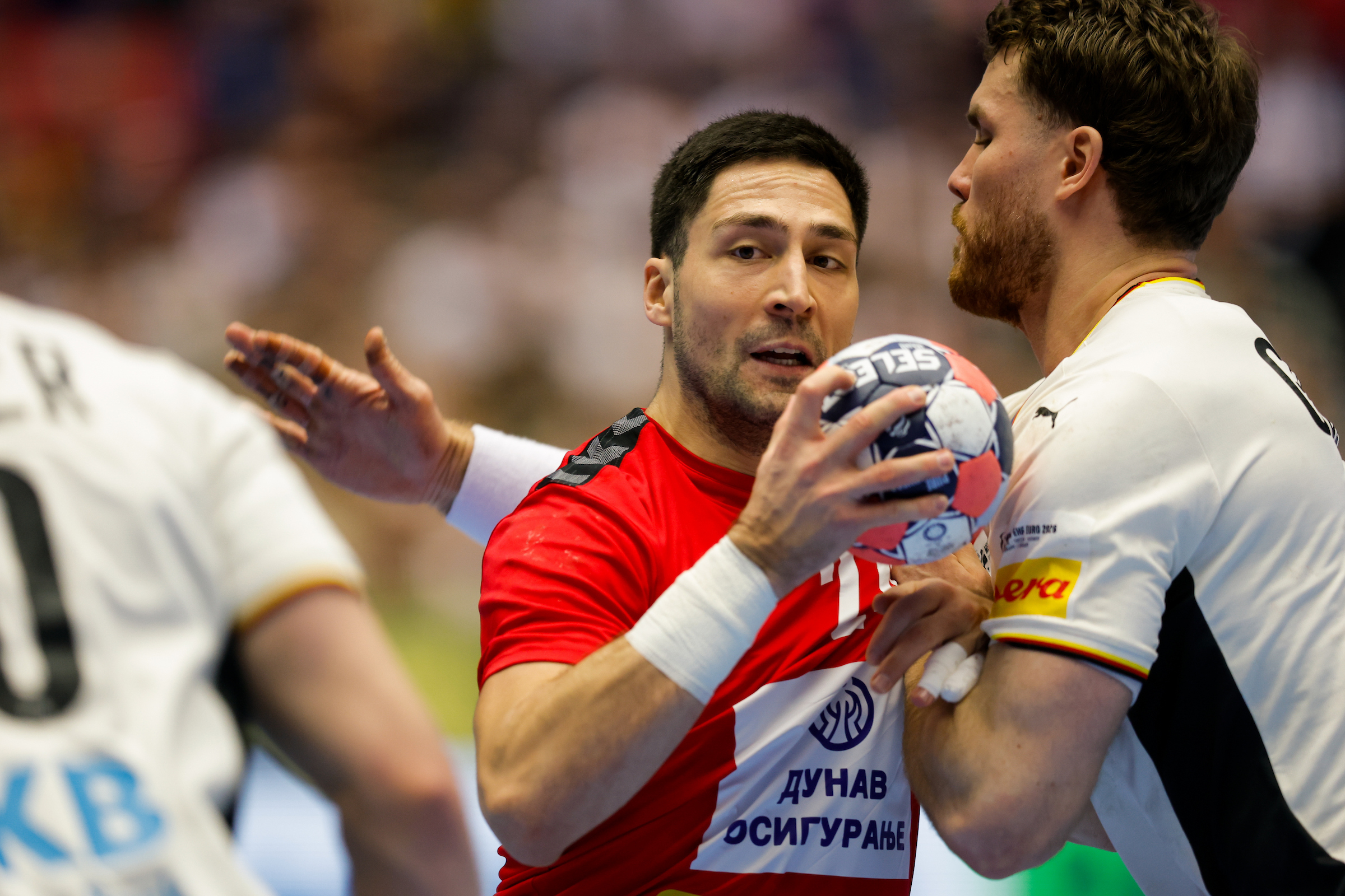 Serbia shock Germany to remain in main round race